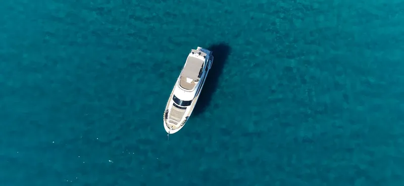  Yacht Photos Pics Aerial view of 2013 Prestige 620 yacht on clear blue water.