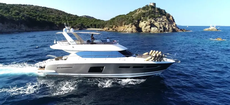  Yacht Photos Pics Luxury 2013 Prestige 620 yacht cruising near scenic rocky coastline.