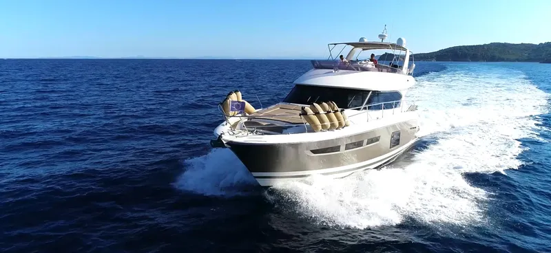  Yacht Photos Pics Luxurious 2013 Prestige 620 yacht cruising on open sea under clear blue sky.