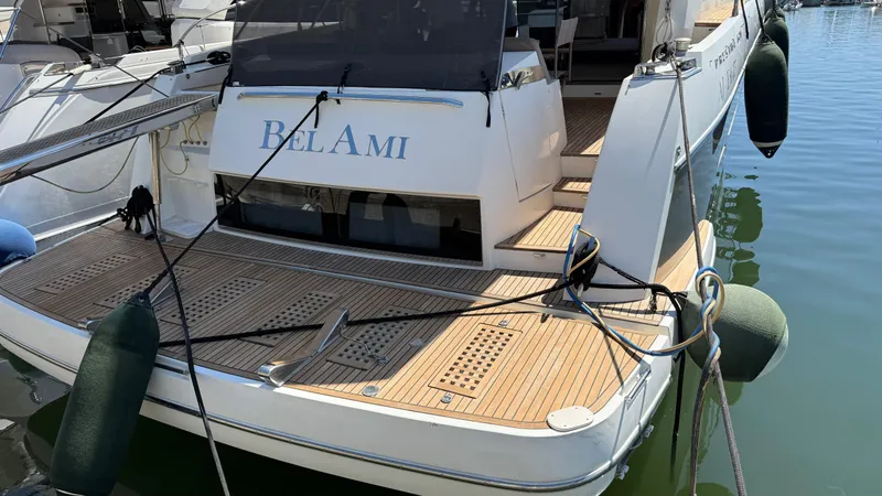  Yacht Photos Pics Luxury yacht "Bel Ami" docked, Prestige 620 model, 2013, with wooden deck and mooring lines.