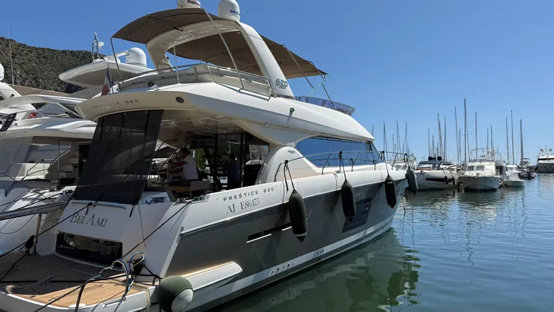  Yacht Photos Pics Luxury 2013 Prestige 620 yacht docked in a marina, surrounded by other boats.