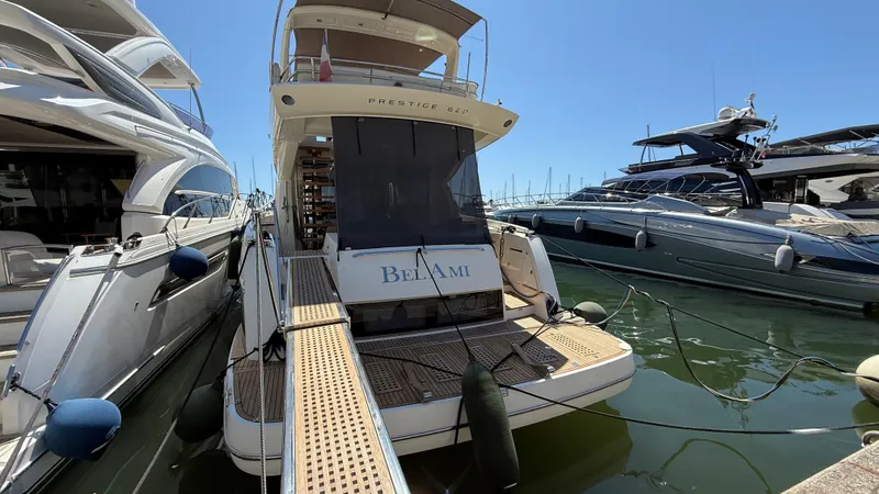  Yacht Photos Pics Luxury yacht "Bel Ami" docked, Prestige 620 model, 2013, in a marina under clear blue skies.