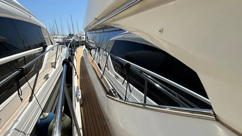  Yacht Photos Pics Side view of a 2013 Prestige 620 yacht docked at a marina.