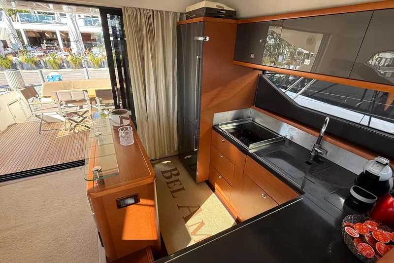  Yacht Photos Pics Luxurious kitchen interior of 2013 Prestige 620 yacht with modern amenities and outdoor view.