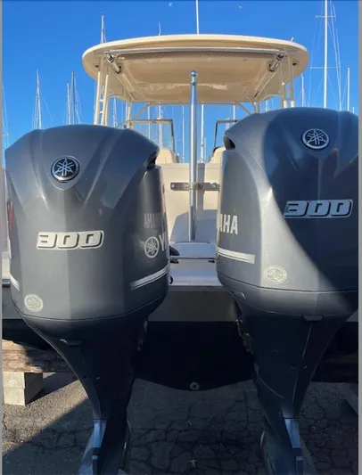 Badger Yacht Photos Pics 2015 Grady-White Freedom 307 with twin Yamaha 300 engines, docked under clear blue sky.