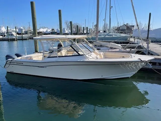 Badger Yacht Photos Pics 2015 Grady-White Freedom 307 boat docked in a marina under clear blue skies.