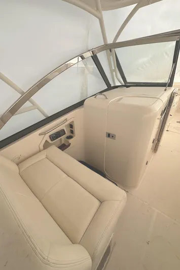 Badger Yacht Photos Pics 2015 Grady-White Freedom 307 boat interior with beige seating and dashboard.