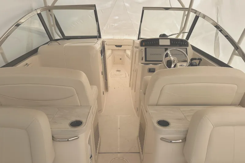 Badger Yacht Photos Pics 2015 Grady-White Freedom 307 boat interior with beige seating and modern dashboard.