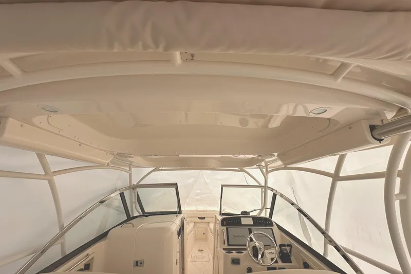 Badger Yacht Photos Pics 2015 Grady-White Freedom 307 boat interior with helm and seating area.