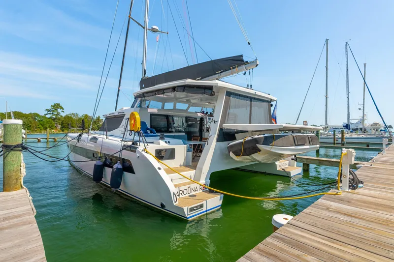 Carolina Red Yacht Photos Pics 2024 St Francis 460 catamaran docked at a marina under clear blue skies.