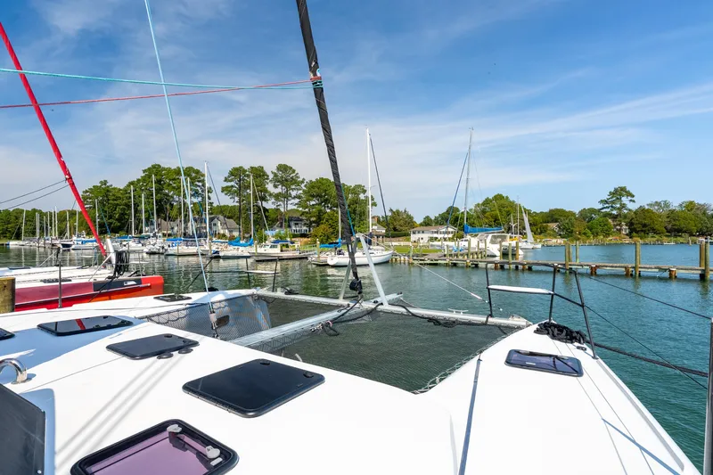 Carolina Red Yacht Photos Pics 2024 St Francis 460 catamaran docked in a scenic marina with sailboats.