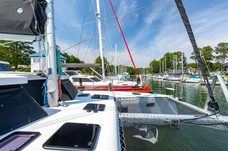 Carolina Red Yacht Photos Pics 2024 St Francis 460 catamaran docked in a scenic marina with sailboats.