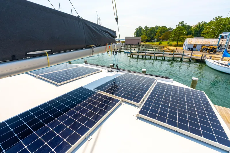 Carolina Red Yacht Photos Pics Solar panels on 2024 St Francis 460 catamaran docked by a scenic waterfront.