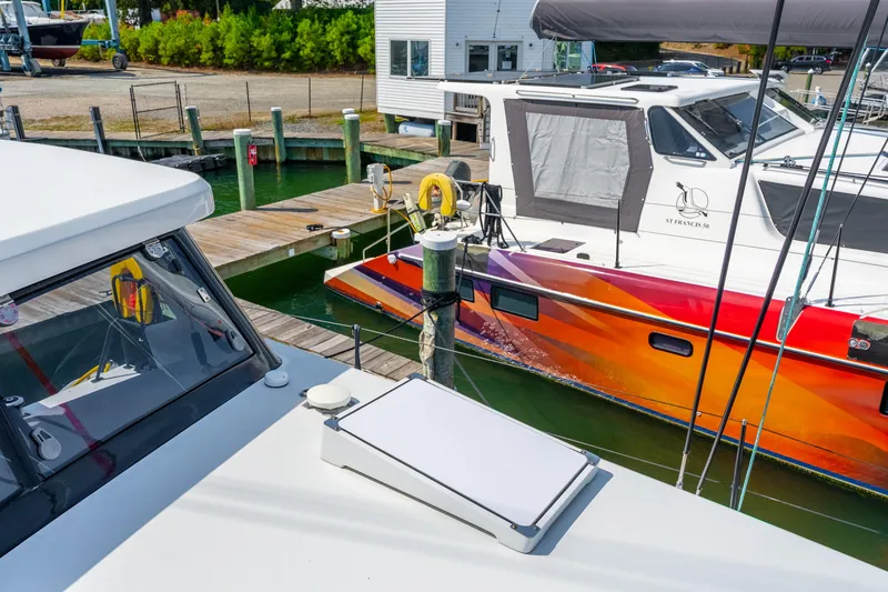 Carolina Red Yacht Photos Pics 2024 St Francis 460 catamaran docked, vibrant hull design, marina setting.
