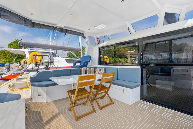 Carolina Red Yacht Photos Pics 2024 St Francis 460 yacht interior with seating, table, and sliding glass doors.