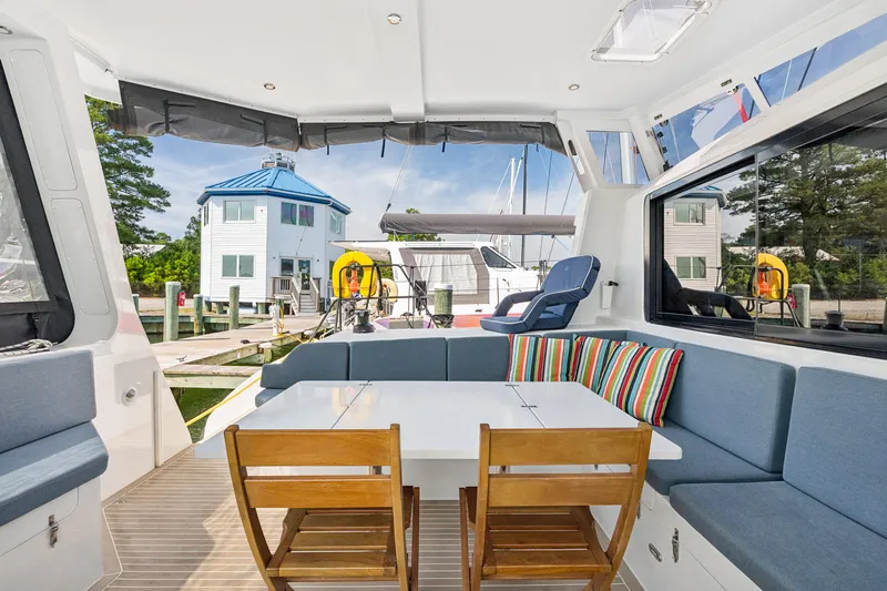 Carolina Red Yacht Photos Pics 2024 St Francis 460 yacht interior with seating, table, and marina view.