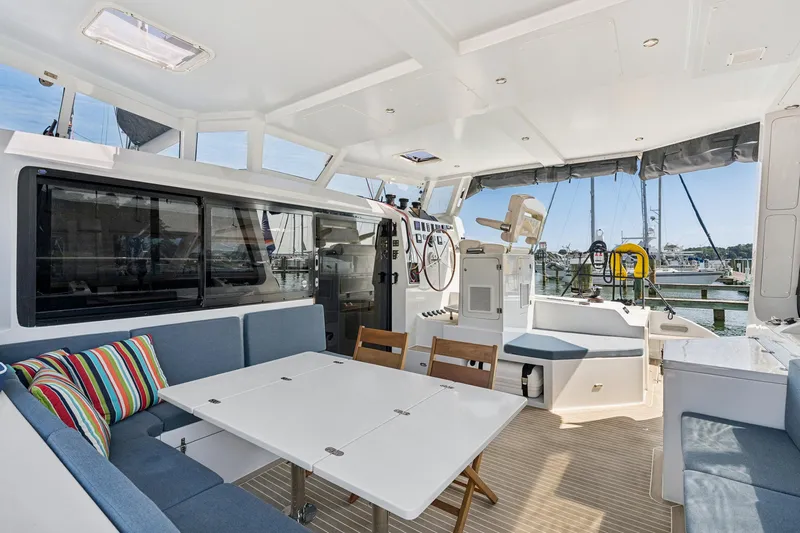 Carolina Red Yacht Photos Pics Luxurious 2024 St Francis 460 yacht interior with seating, table, and helm station.