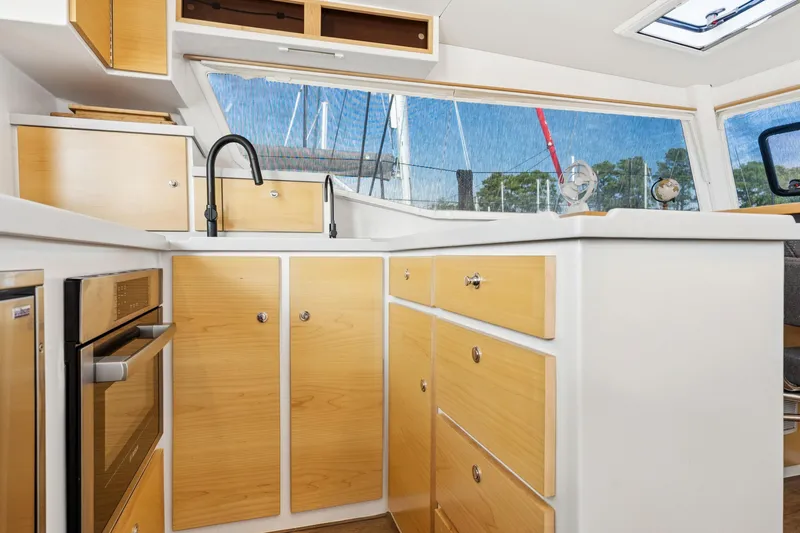 Carolina Red Yacht Photos Pics Modern kitchen interior of 2024 St Francis 460 yacht with wood cabinets and sleek design.