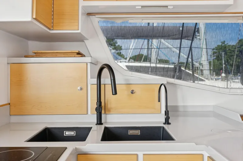 Carolina Red Yacht Photos Pics Modern kitchen interior on 2024 St Francis 460 yacht with dual sinks and wooden cabinets.