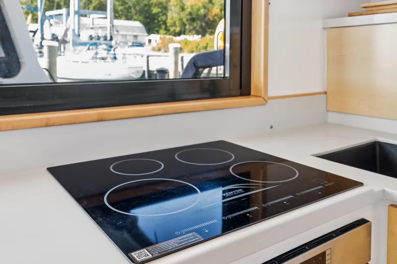 Carolina Red Yacht Photos Pics Modern kitchen in 2024 St Francis 460 yacht with induction cooktop and window view.