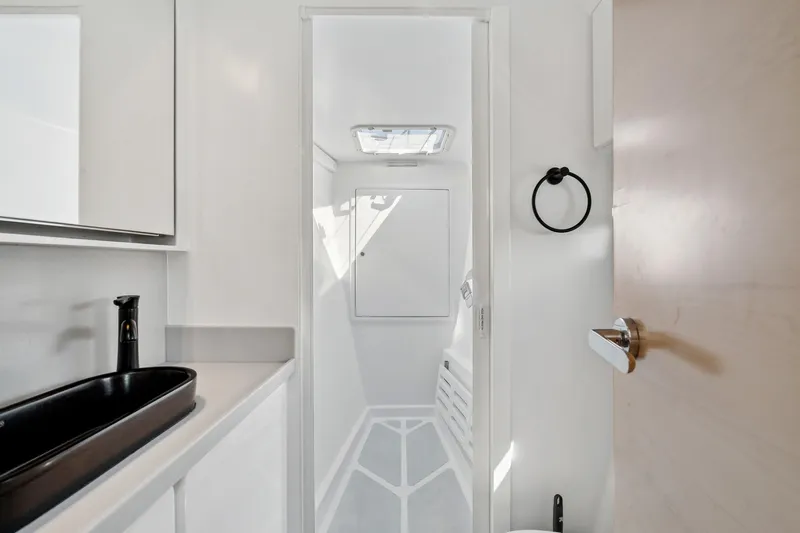 Carolina Red Yacht Photos Pics Modern bathroom interior in 2024 St Francis 460 yacht, featuring sleek black sink and minimalist design.