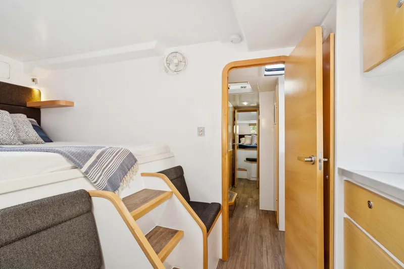 Carolina Red Yacht Photos Pics 2024 St Francis 460 interior with cozy bed, wooden steps, and modern design.