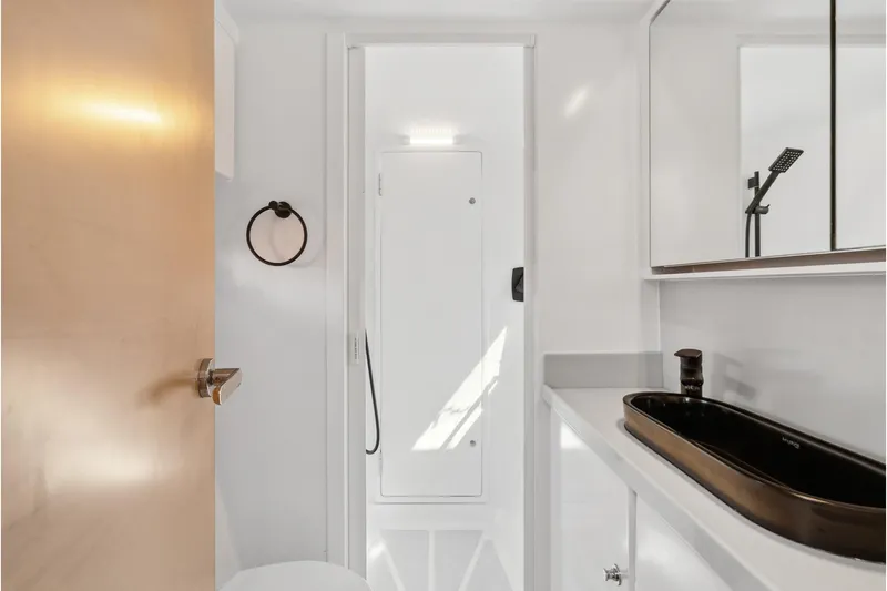 Carolina Red Yacht Photos Pics Modern bathroom in 2024 St Francis 460 yacht with sleek black sink and minimalist design.