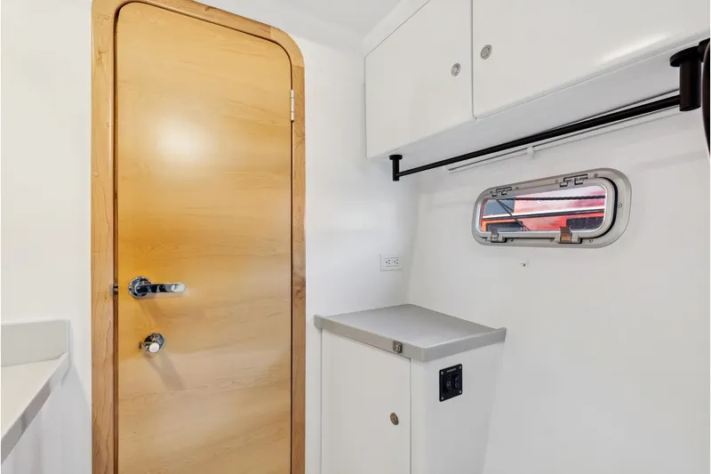 Carolina Red Yacht Photos Pics 2024 St Francis 460 interior with wooden door, white cabinets, and small window.