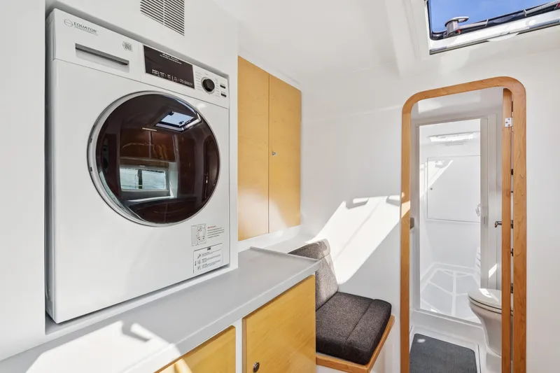 Carolina Red Yacht Photos Pics Modern interior of 2024 St Francis 460 yacht with washer, seating, and bathroom.