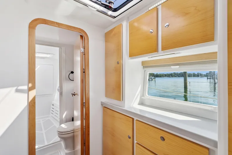 Carolina Red Yacht Photos Pics Modern bathroom interior on 2024 St Francis 460 yacht with wooden cabinets and scenic window view.