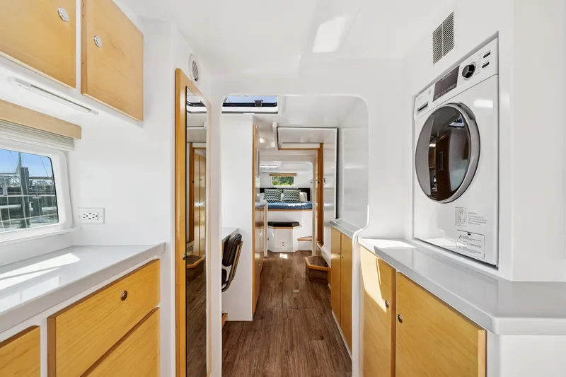 Carolina Red Yacht Photos Pics Modern interior of 2024 St Francis 460 yacht with wood accents and washer-dryer unit.