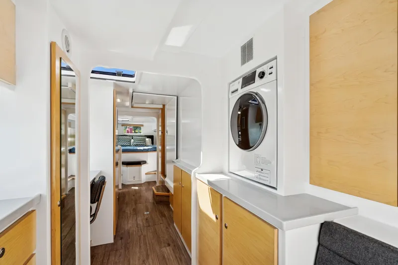 Carolina Red Yacht Photos Pics Modern interior of 2024 St Francis 460 yacht with washer, wood accents, and cozy seating.