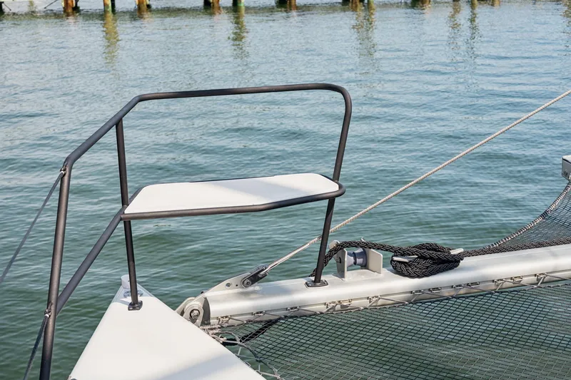 Carolina Red Yacht Photos Pics 2024 St Francis 460 catamaran bow with netting and railing over water.