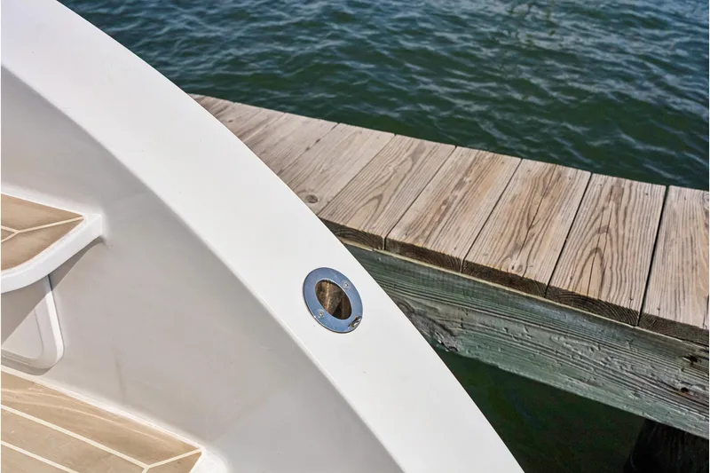 Carolina Red Yacht Photos Pics 2024 St Francis 460 yacht docked beside wooden pier, close-up view.
