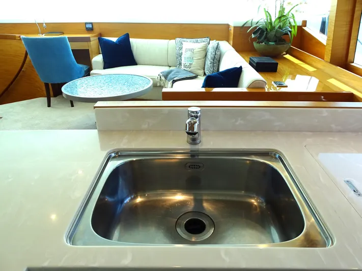 Quintessa Yacht Photos Pics Modern yacht interior with sink, lounge area, and stylish decor on a 2014 Horizon PC52.