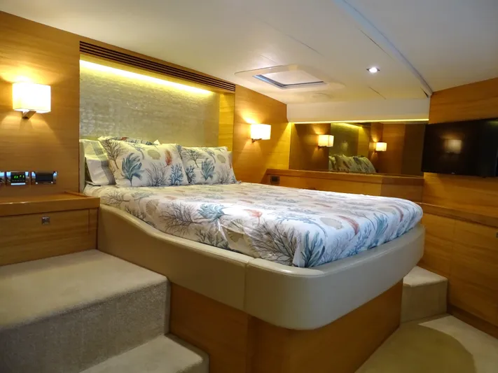 Quintessa Yacht Photos Pics Luxurious cabin interior of 2014 Horizon PC52 yacht with elegant bedding and ambient lighting.