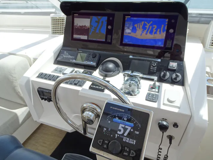 Quintessa Yacht Photos Pics Helm of 2014 Horizon PC52 yacht with navigation screens and controls.