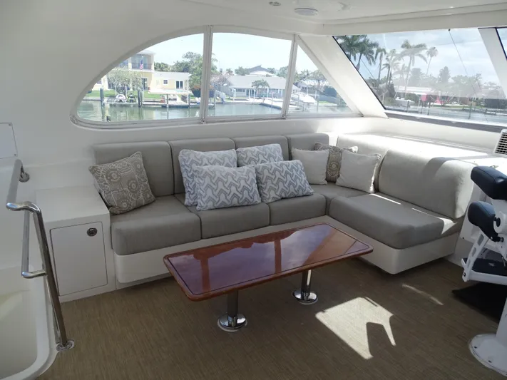 Quintessa Yacht Photos Pics Luxurious interior of 2014 Horizon PC52 yacht with plush seating and elegant table.