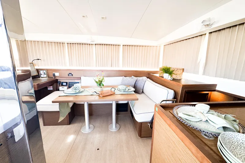 Southern Wild Yacht Photos Pics Luxurious interior of 2018 Lagoon 40 catamaran with elegant dining area and modern decor.