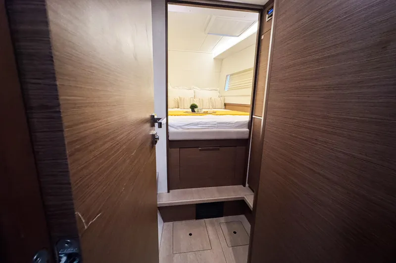 Southern Wild Yacht Photos Pics Interior cabin of 2018 Lagoon 40 catamaran with cozy bed and wooden finish.