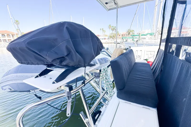 Southern Wild Yacht Photos Pics 2018 Lagoon 40 catamaran deck with covered equipment and seating area in marina.