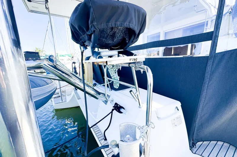 Southern Wild Yacht Photos Pics 2018 Lagoon 40 yacht stern view with covered equipment and marina backdrop.
