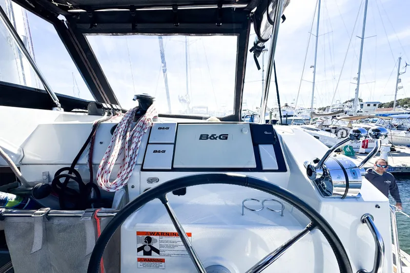 Southern Wild Yacht Photos Pics Cockpit view of 2018 Lagoon 40 catamaran with steering wheel and navigation equipment.