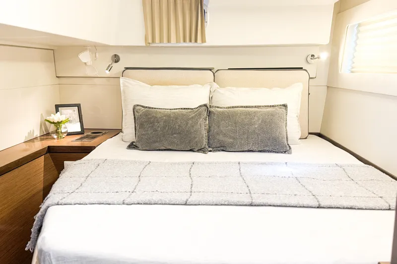 Southern Wild Yacht Photos Pics Luxurious bedroom interior of 2018 Lagoon 40 yacht with cozy bedding and elegant decor.