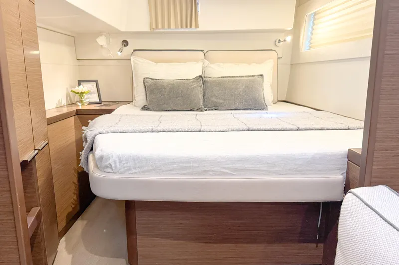 Southern Wild Yacht Photos Pics Luxurious cabin interior of 2018 Lagoon 40 yacht with cozy bed and modern decor.