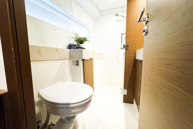 Southern Wild Yacht Photos Pics Modern bathroom interior on 2018 Lagoon 40 yacht, featuring shower and toilet.
