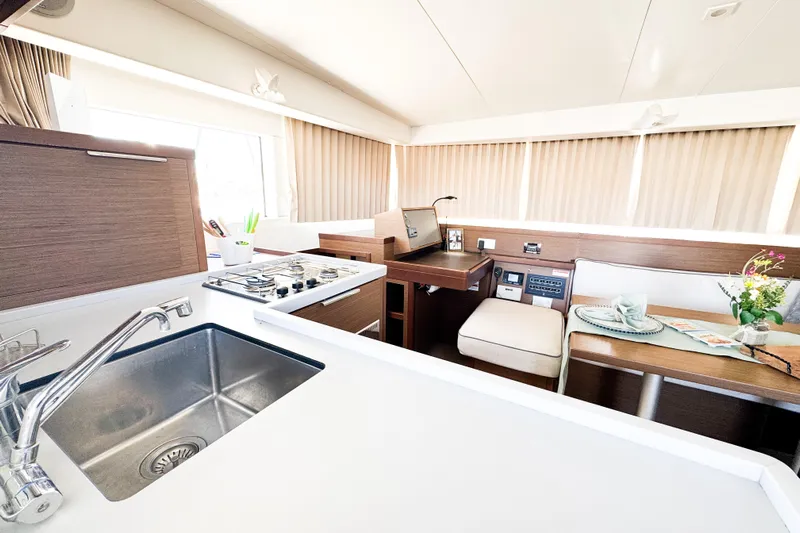 Southern Wild Yacht Photos Pics Modern interior of 2018 Lagoon 40 catamaran with kitchen and dining area.