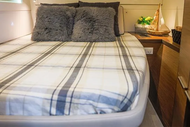 Southern Wild Yacht Photos Pics Cozy bedroom in 2018 Lagoon 40 yacht with plaid bedding and plush pillows.