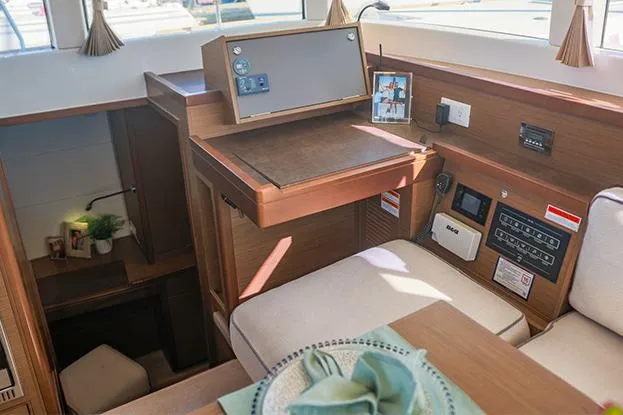 Southern Wild Yacht Photos Pics Interior of 2018 Lagoon 40 catamaran with navigation station and cozy seating area.