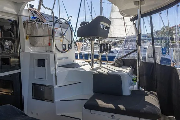 Southern Wild Yacht Photos Pics Interior view of a 2018 Lagoon 40 catamaran, featuring helm and seating area.